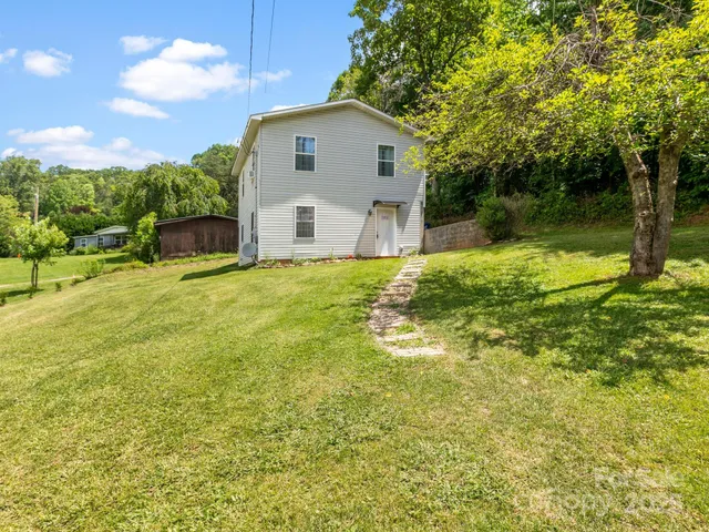 a front view of a house with yard and green space