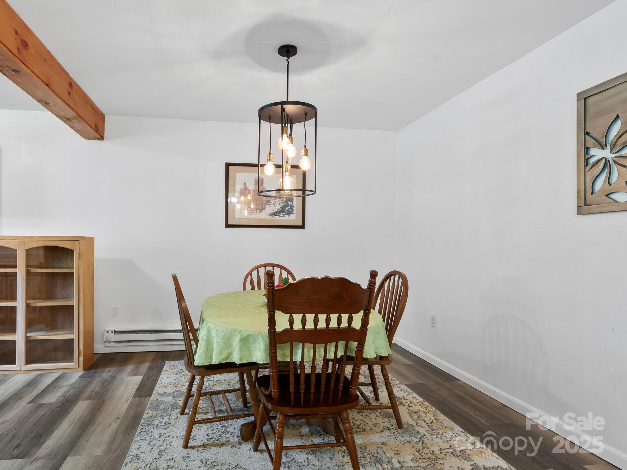 186 Wiggins Road Candler, NC 28715 - Photo 12 of 32 a view of a dining room with furniture and wooden floor