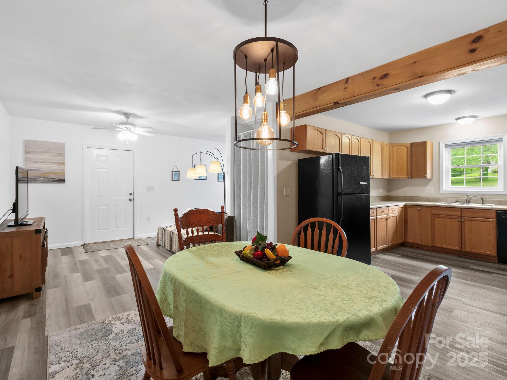 186 Wiggins Road Candler, NC 28715 - Photo 14 of 32 a kitchen with stainless steel appliances granite countertop a dining table chairs and a refrigerator