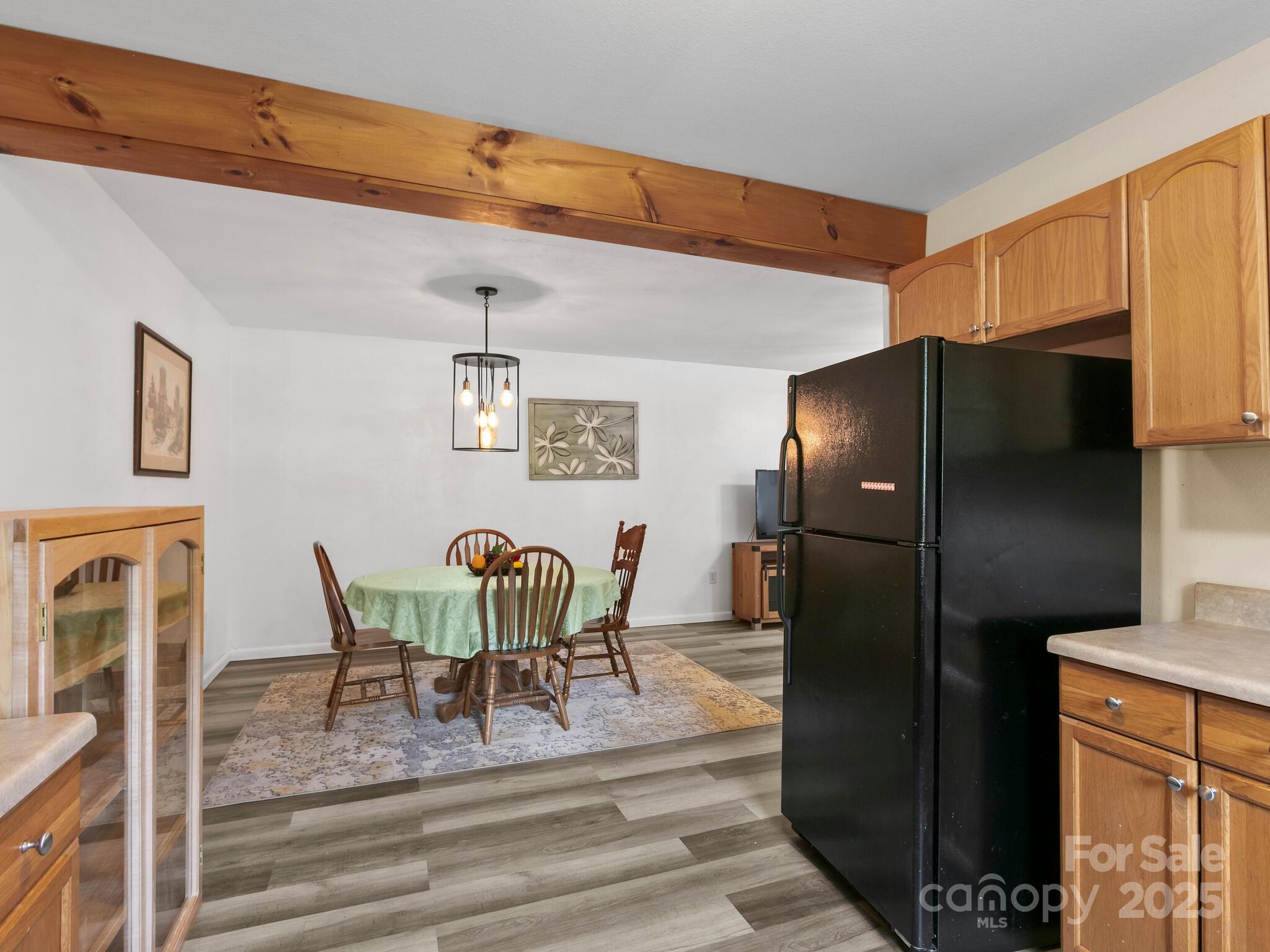 186 Wiggins Road Candler, NC 28715 - Photo 17 of 32 a view of a dining room with furniture and a refrigerator