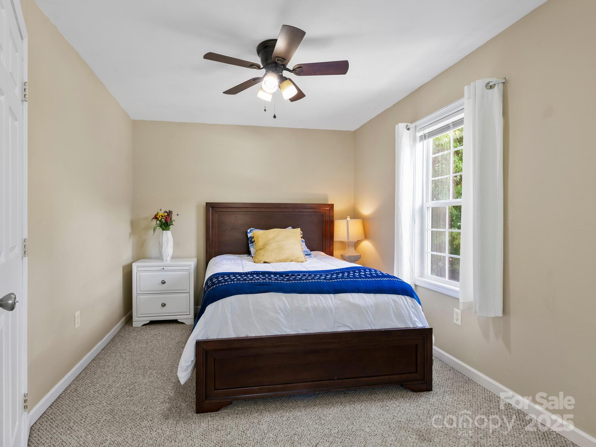 186 Wiggins Road Candler, NC 28715 - Photo 19 of 32 a bedroom with a bed and a window