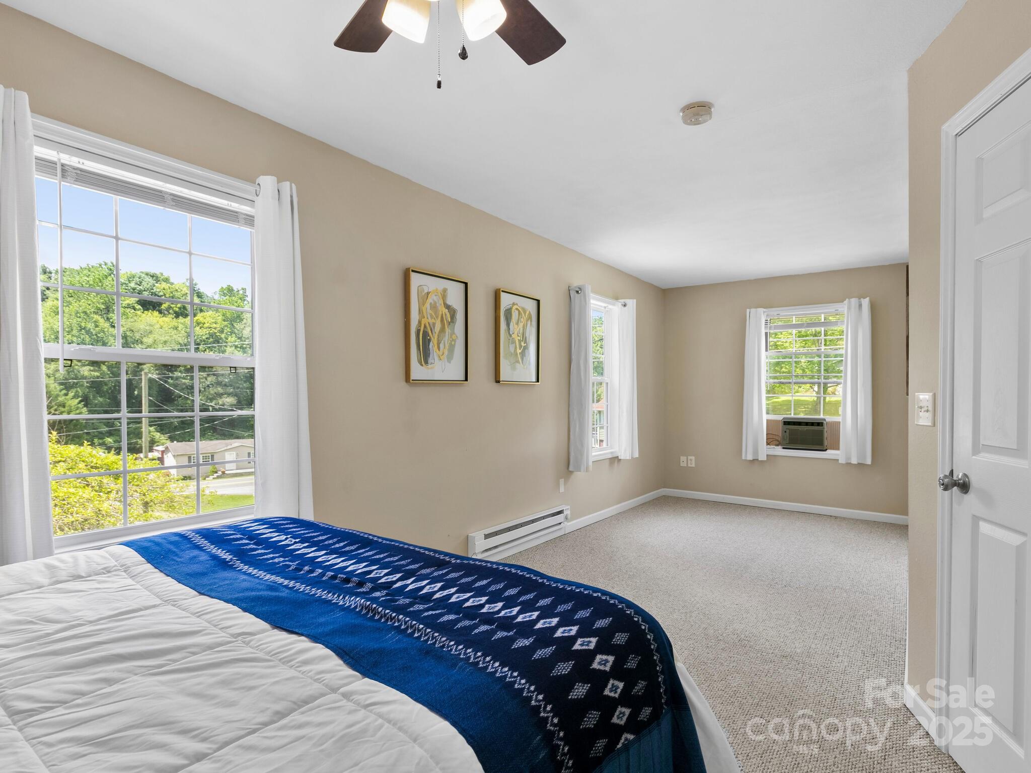 186 Wiggins Road Candler, NC 28715 - Photo 21 of 32 a bedroom with a bed and a window