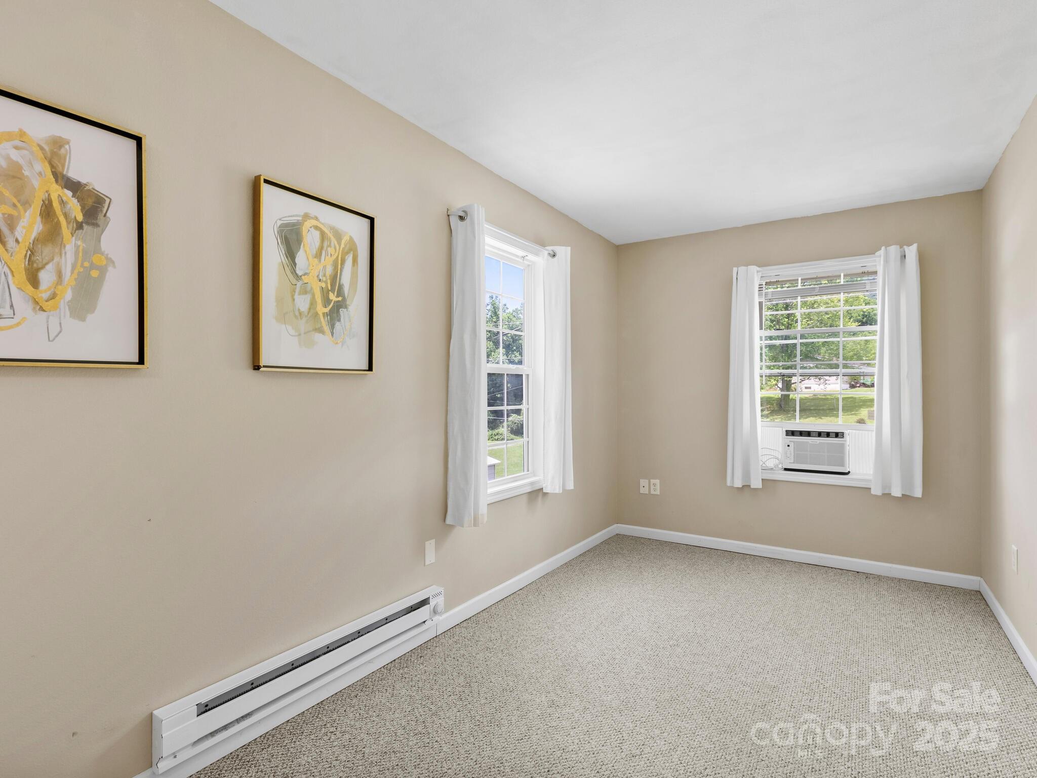 186 Wiggins Road Candler, NC 28715 - Photo 22 of 32 an empty room with windows