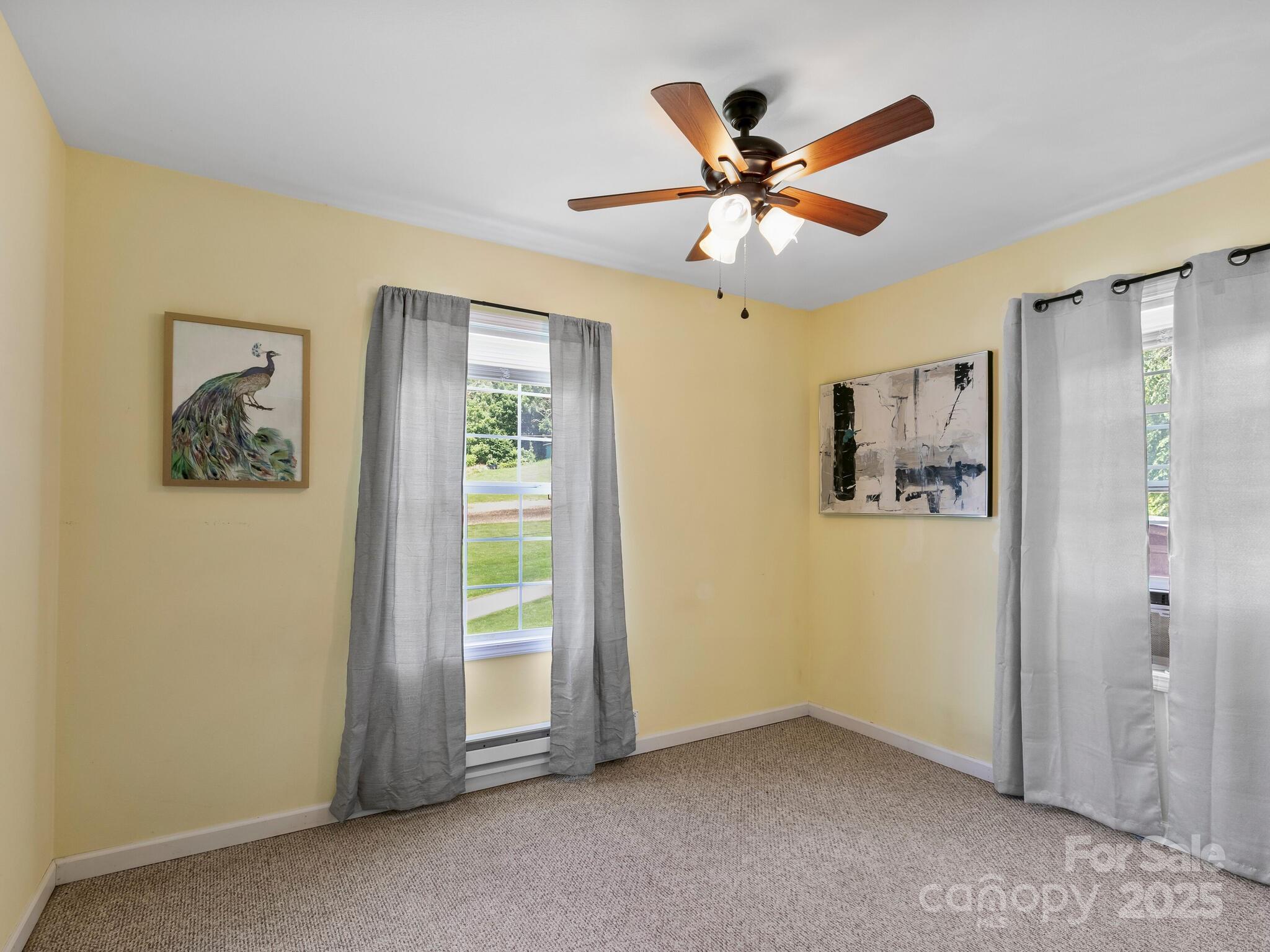 186 Wiggins Road Candler, NC 28715 - Photo 25 of 32 a view of a livingroom with a ceiling fan and window