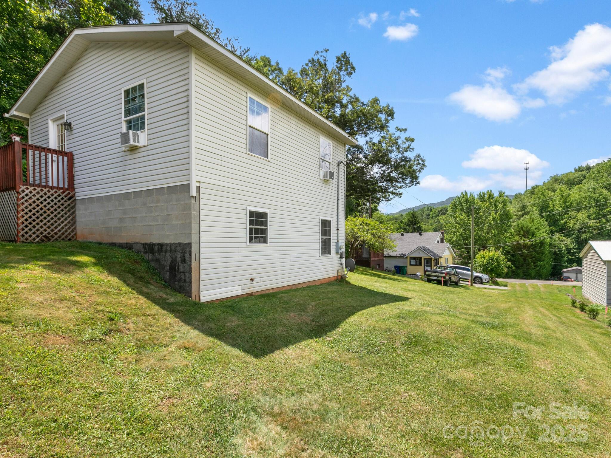 186 Wiggins Road Candler, NC 28715 - Photo 30 of 32 a view of a house with backyard and sitting area