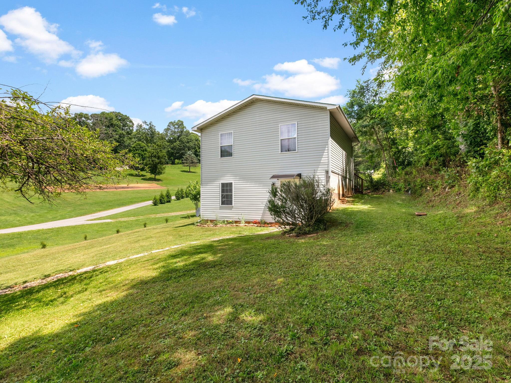 186 Wiggins Road Candler, NC 28715 - Photo 4 of 32 a view of a house with a backyard