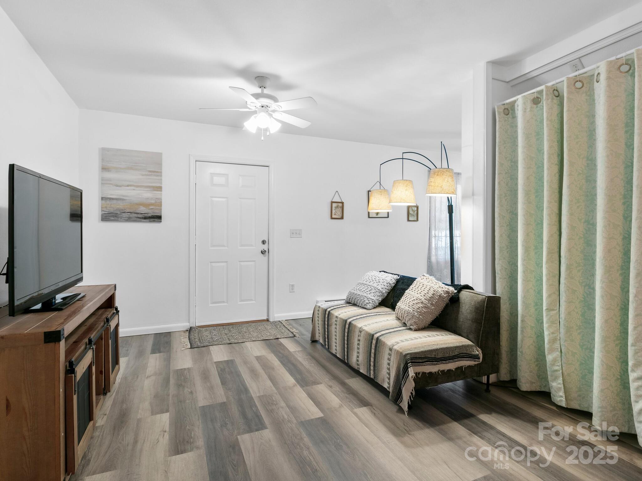 186 Wiggins Road Candler, NC 28715 - Photo 7 of 32 a living room with furniture and a flat screen tv