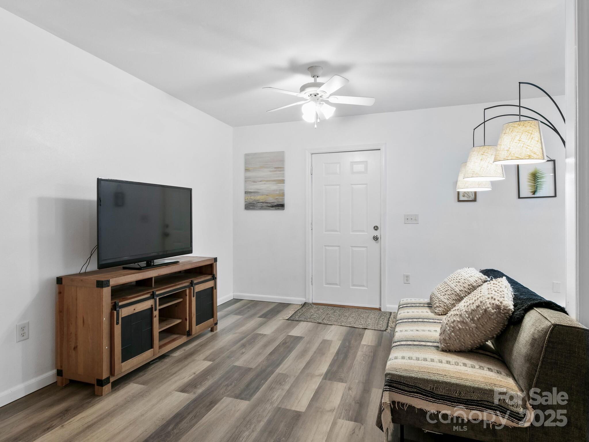 186 Wiggins Road Candler, NC 28715 - Photo 8 of 32 a living room with furniture and a flat screen tv