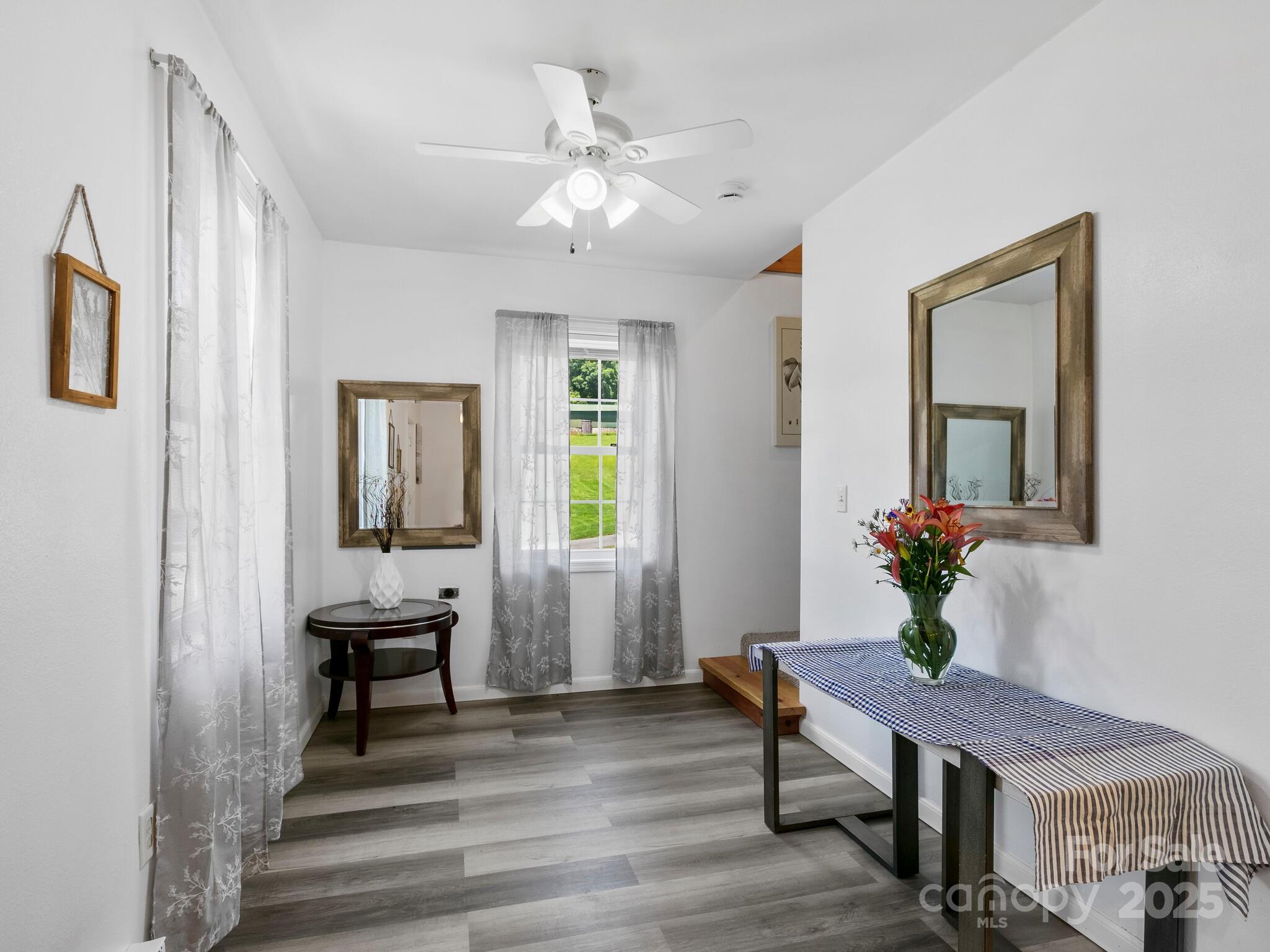 186 Wiggins Road Candler, NC 28715 - Photo 10 of 32 a living room with furniture and a potted plant