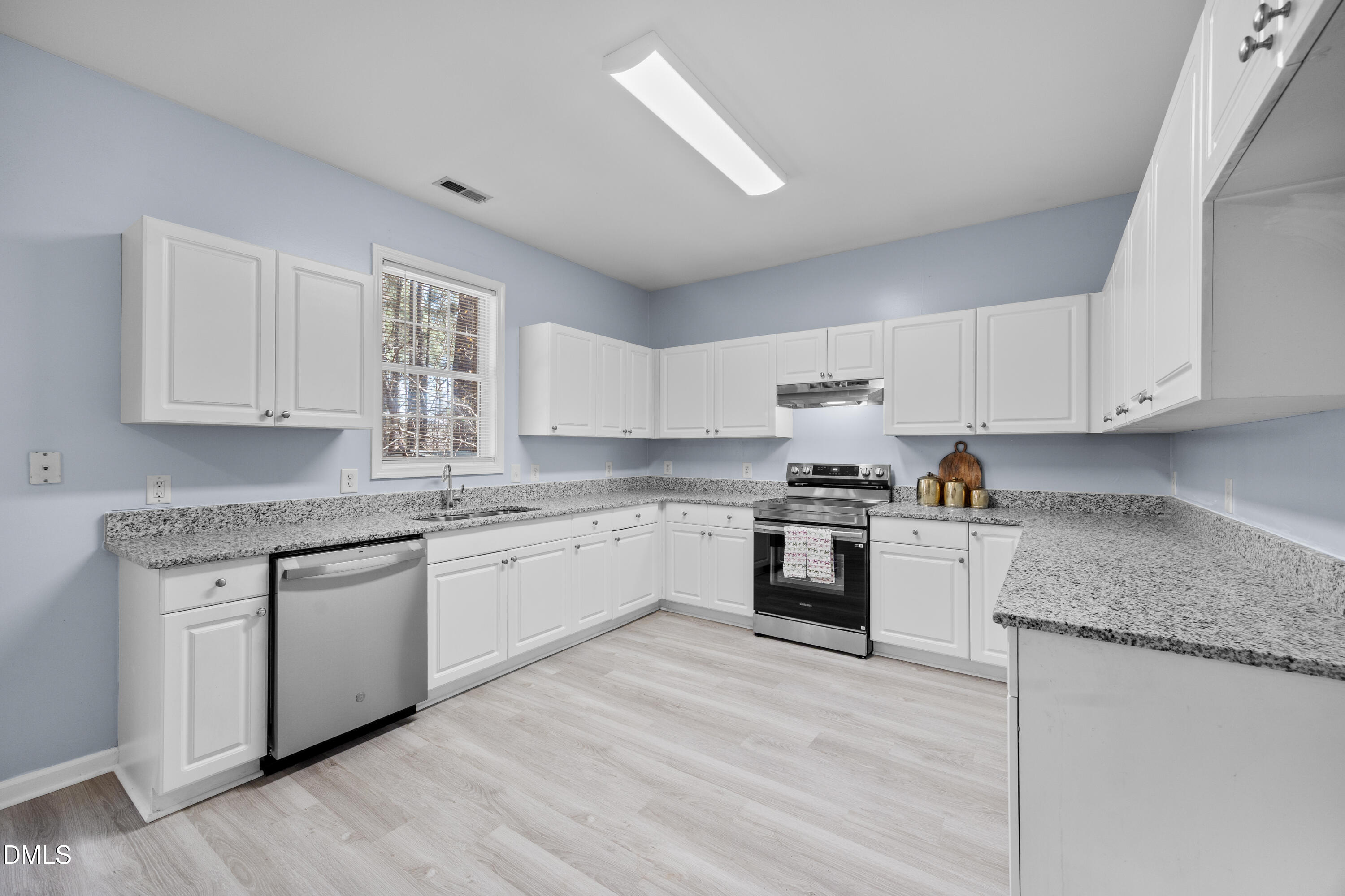 2109 Star Sapphire Drive Raleigh, NC 27610 - Photo 10 of 37 a kitchen with granite countertop white cabinets and white appliances