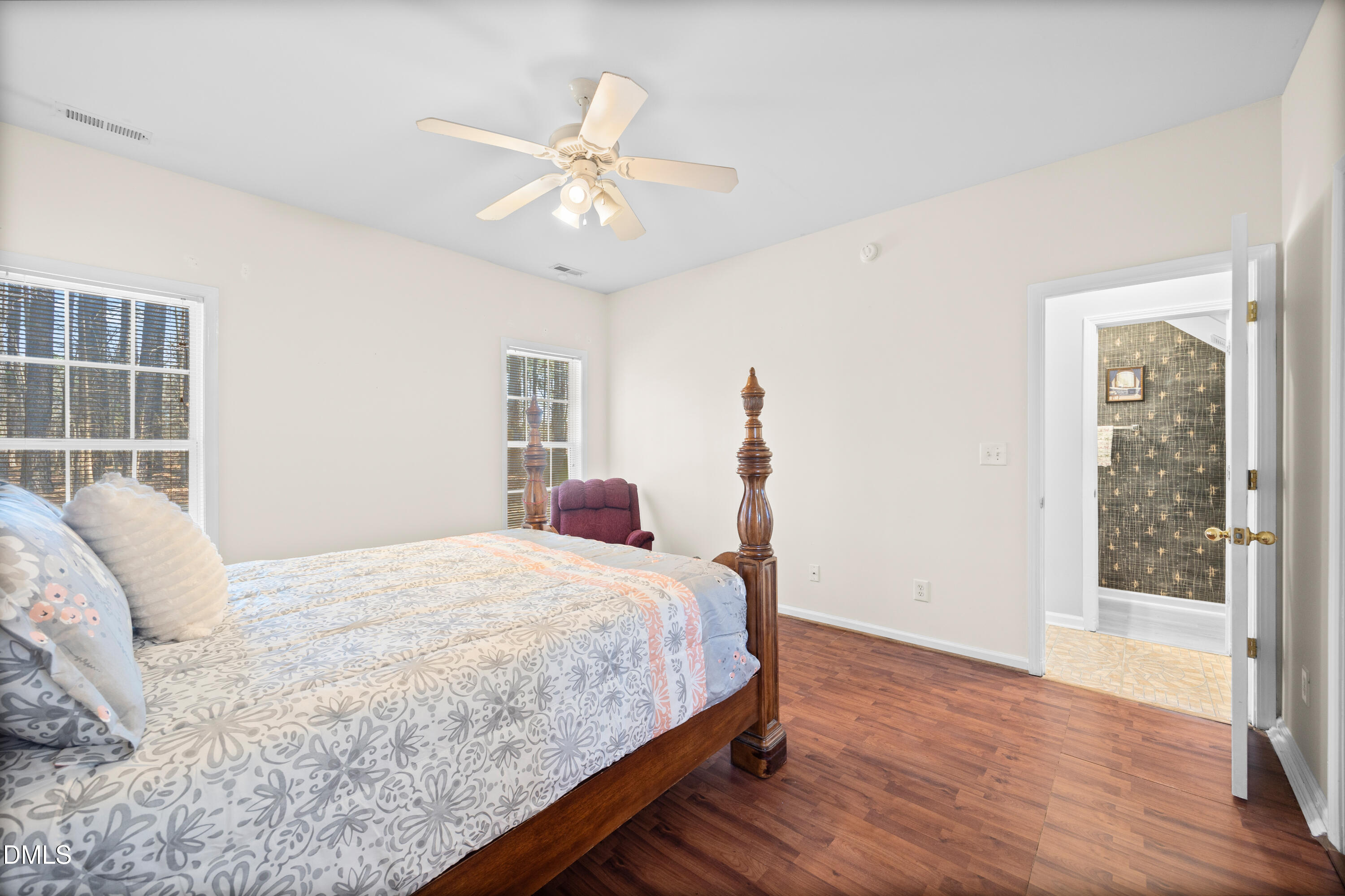 2109 Star Sapphire Drive Raleigh, NC 27610 - Photo 15 of 37 a bedroom with a large bed and a chandelier