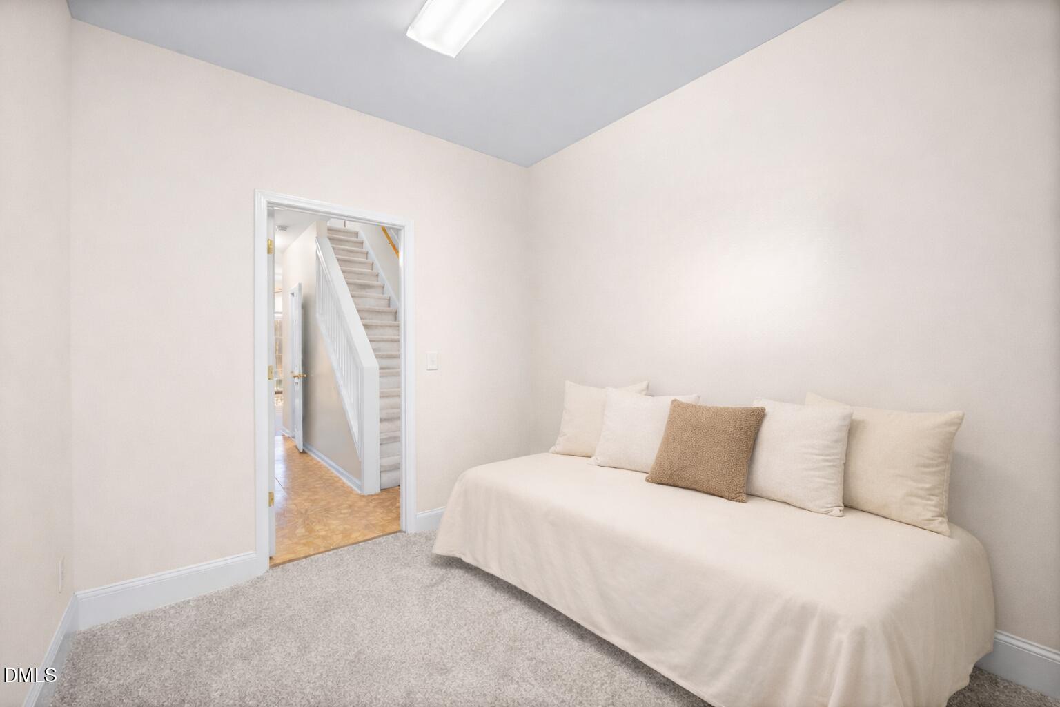 2109 Star Sapphire Drive Raleigh, NC 27610 - Photo 21 of 37 a bedroom with a bed and a night stand