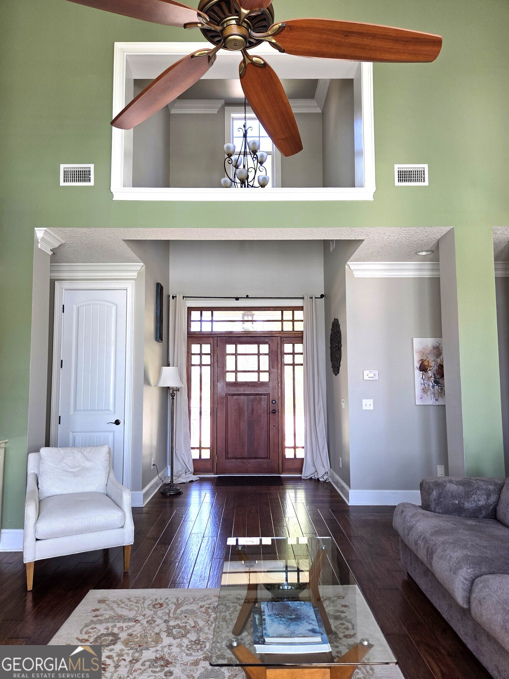 300 Hammond Powell Road Hazlehurst, GA 31539 - Photo 35 of 91 a living room with a couch and a chandelier