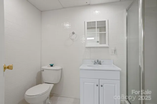 a bathroom with a sink toilet and a mirror