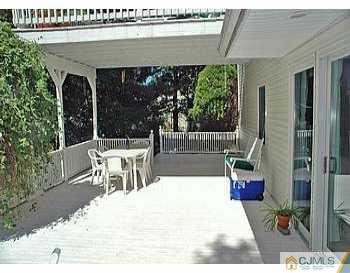 18 Skytop Road Edison, NJ 08820 - Photo 8 of 8 a view of a patio with a table and chairs