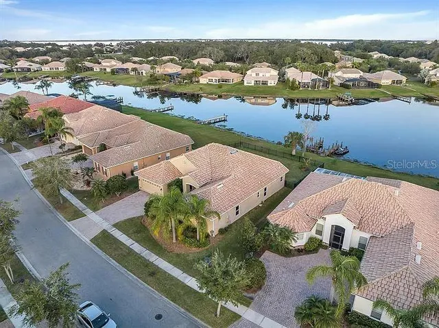an aerial view of a house with a lake view