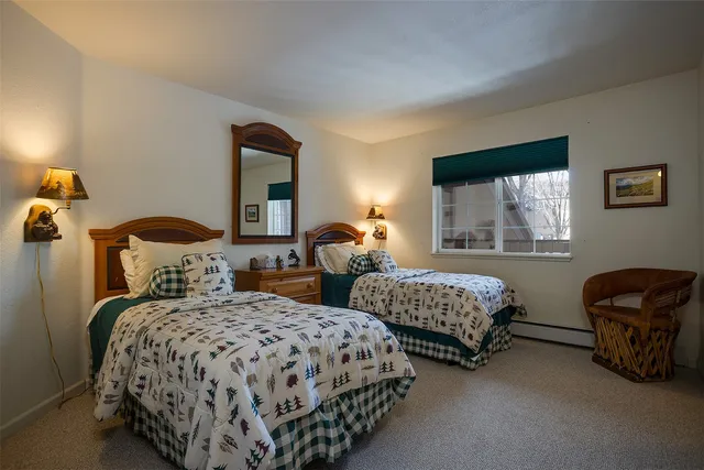 a bedroom with two beds and a window