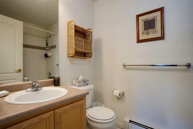 a bathroom with a sink mirror vanity and toilet