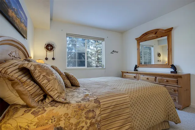 a bedroom with a bed and a dresser