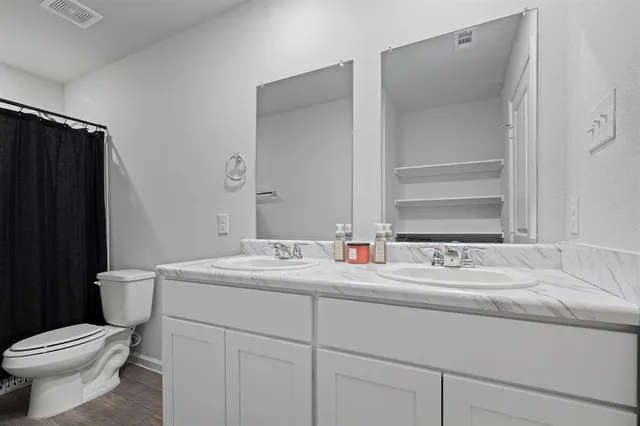 a bathroom with a sink toilet and mirror