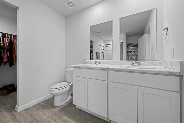 a bathroom with a sink toilet and mirror