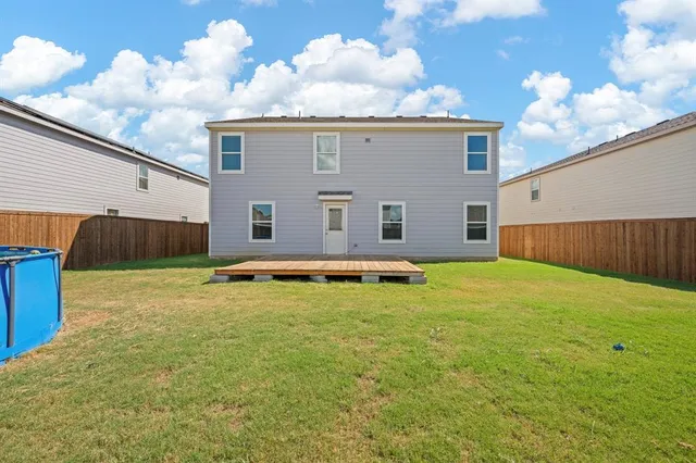 a view of a house with swimming pool and a yard