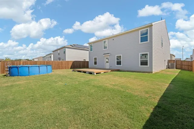 a house view with swimming pool and yard