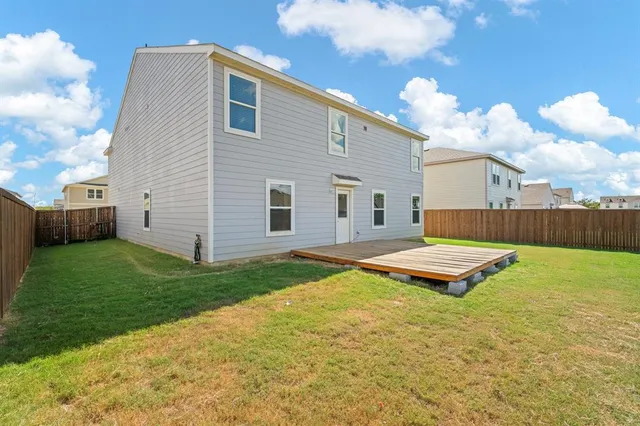 a view of a backyard with a table and chair