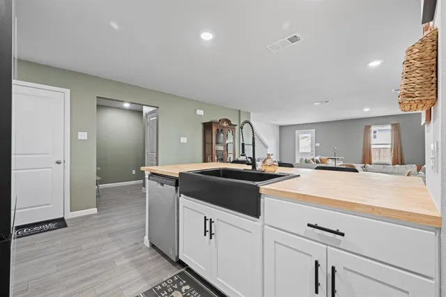a kitchen with a sink and a stove top oven