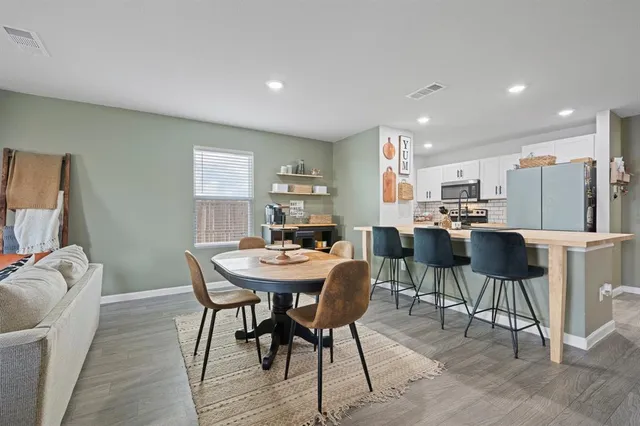 a view of a dining room with furniture and a chandelier