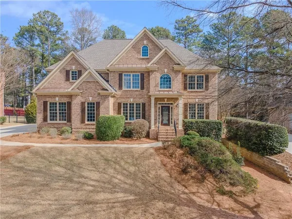 a front view of a house with a yard