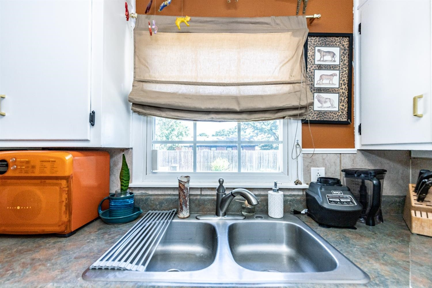 2820 62nd Street Lubbock, TX 79413 - Photo 19 of 43 a kitchen with a sink window and cabinets