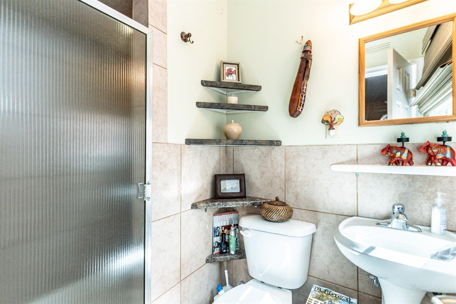 2820 62nd Street Lubbock, TX 79413 - Photo 26 of 43 a bathroom with a sink a toilet and a mirror