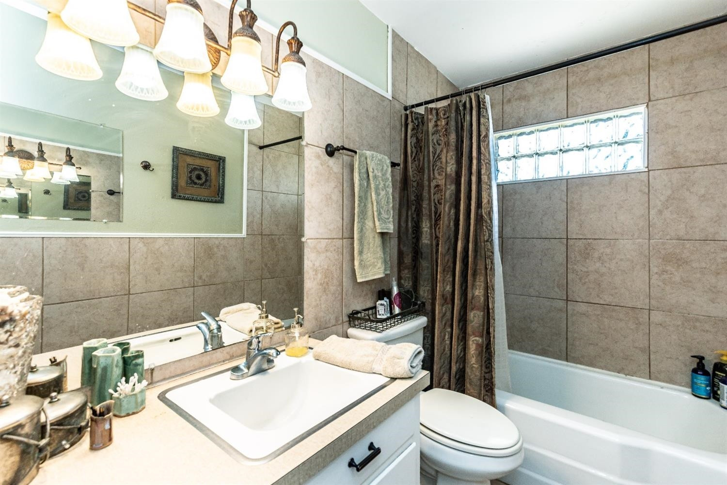 2820 62nd Street Lubbock, TX 79413 - Photo 31 of 43 a bathroom with a sink a toilet and shower