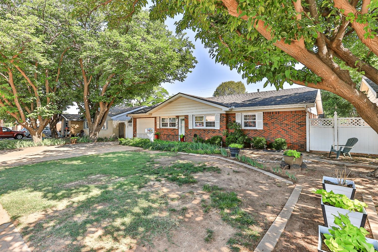 2820 62nd Street Lubbock, TX 79413 - Photo 4 of 43 a front view of a house with a garden