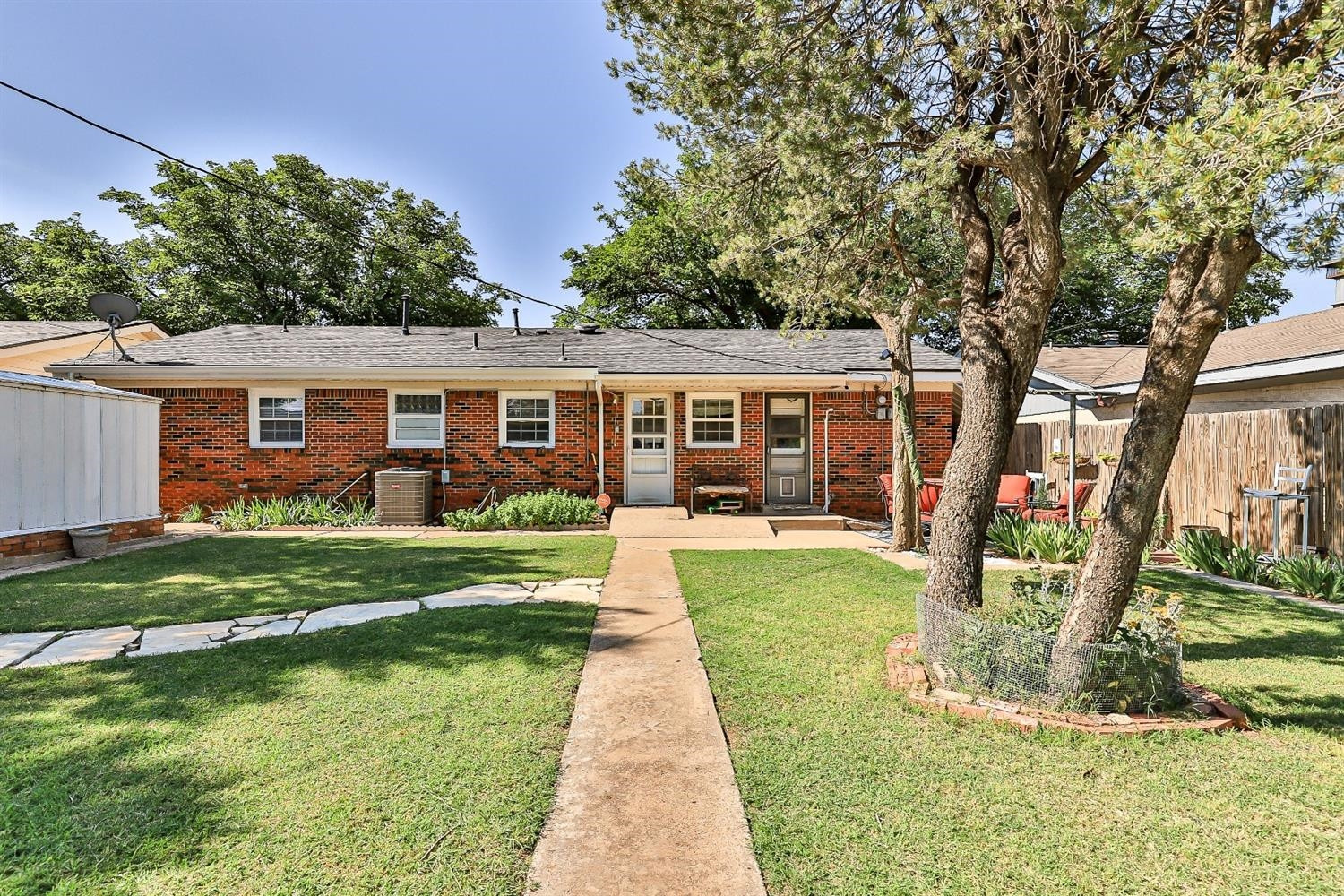 2820 62nd Street Lubbock, TX 79413 - Photo 42 of 43 a front view of a house with a yard table and chairs