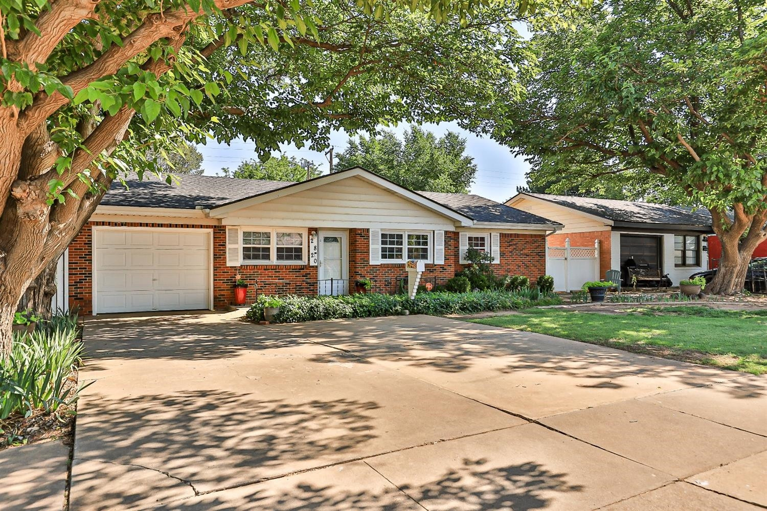 2820 62nd Street Lubbock, TX 79413 - Photo 6 of 43 a front view of a house with a garden