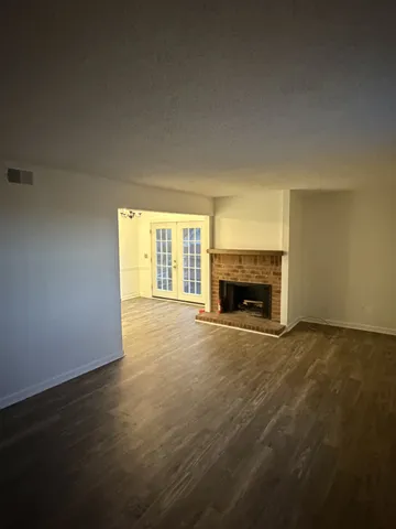 a view of empty room with a fireplace
