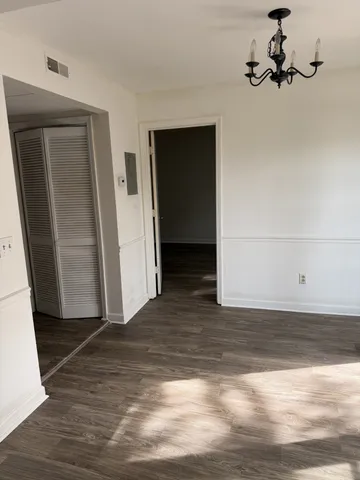a view of a room with wooden floor and cabinet