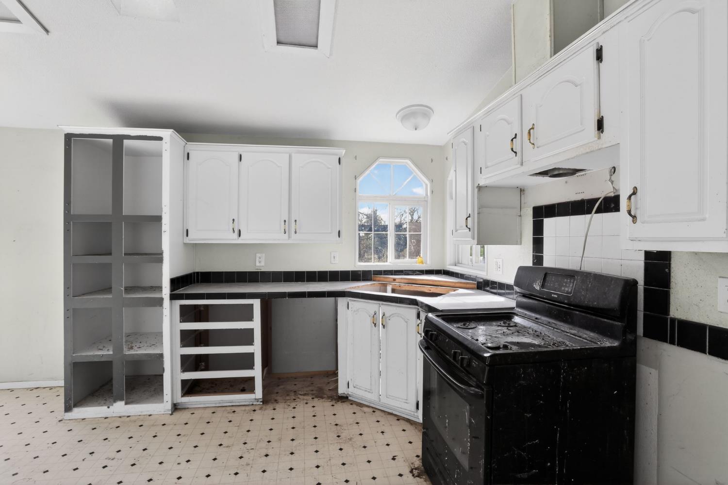 7212 Fox Corning, CA 96021 - Photo 15 of 36 a kitchen with granite countertop a sink stove and cabinets