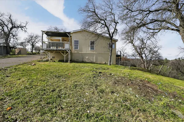 a view of a house with wooden fence