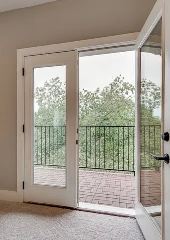 a view of empty room with wooden floor and floor to ceiling window