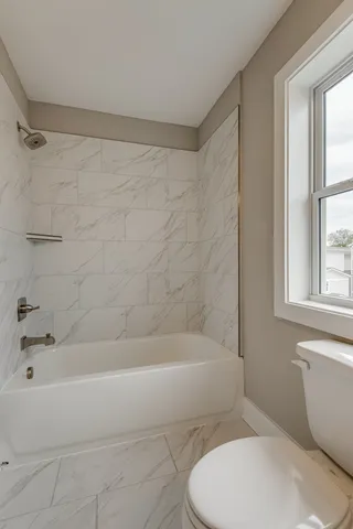 a bathroom with a toilet and bathtub