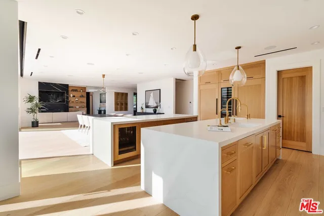 a large kitchen with kitchen island a sink appliances and cabinets