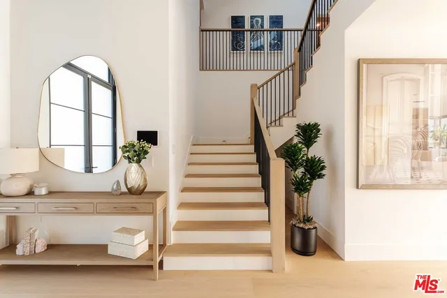 a view of entryway and hall with wooden floor