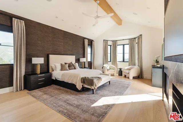 a bedroom with a bed and a flat screen television