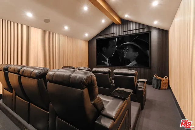 a living room with a black white checkered floor with a gaming machine and appliances