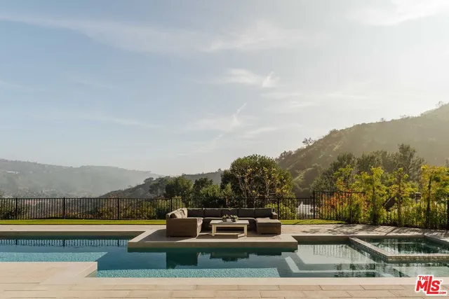 a view of a patio with couches and a table and chairs with garden view