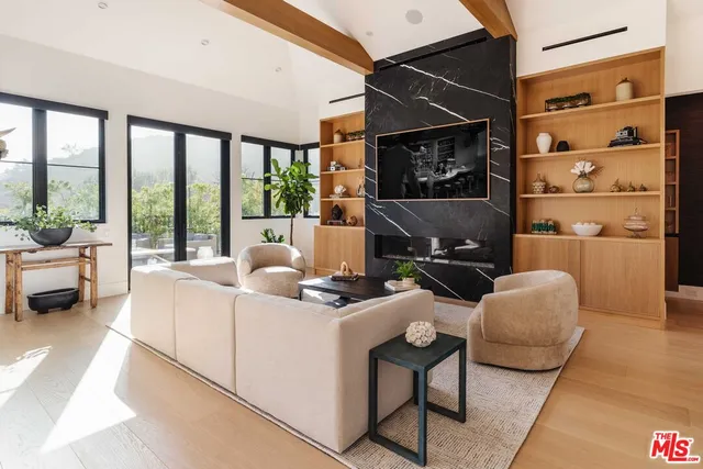 a living room with furniture a rug and a large window
