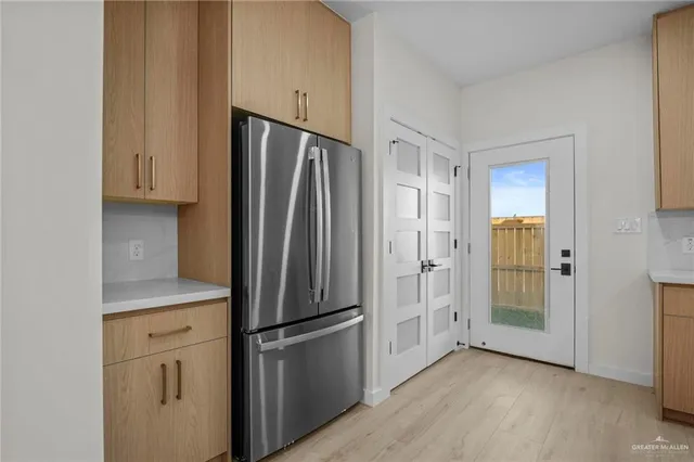 a kitchen with stainless steel appliances a refrigerator and cabinets